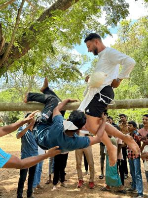 A traditional game played by an volunteer with the locals Photo