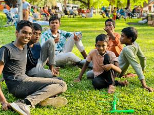 Boys relaxing on the ground during the festival Photo
