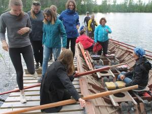 Volunteers trying traditional church boat rowing as a team Photo